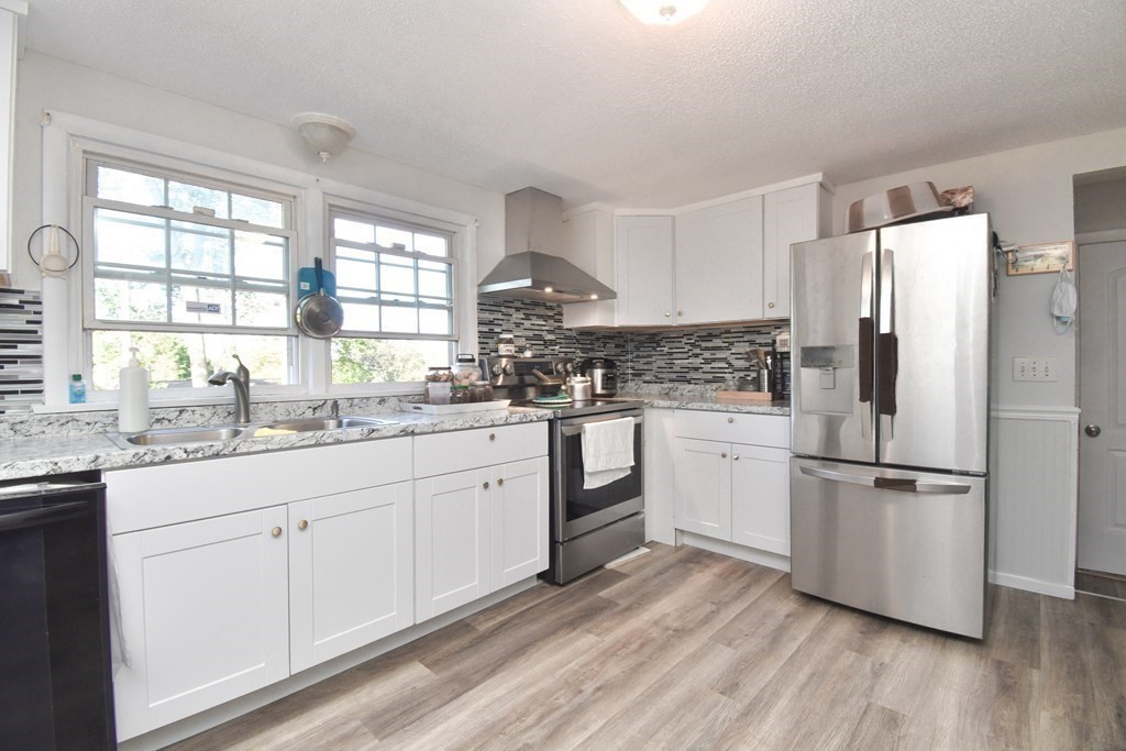 70 Intervale Road Springfield, MA 01118 - Photo 4 of 39 a kitchen with granite countertop white cabinets and white stainless steel appliances