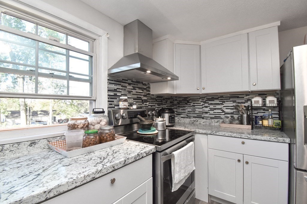 70 Intervale Road Springfield, MA 01118 - Photo 7 of 39 a kitchen with stainless steel appliances granite countertop a sink stove and cabinets