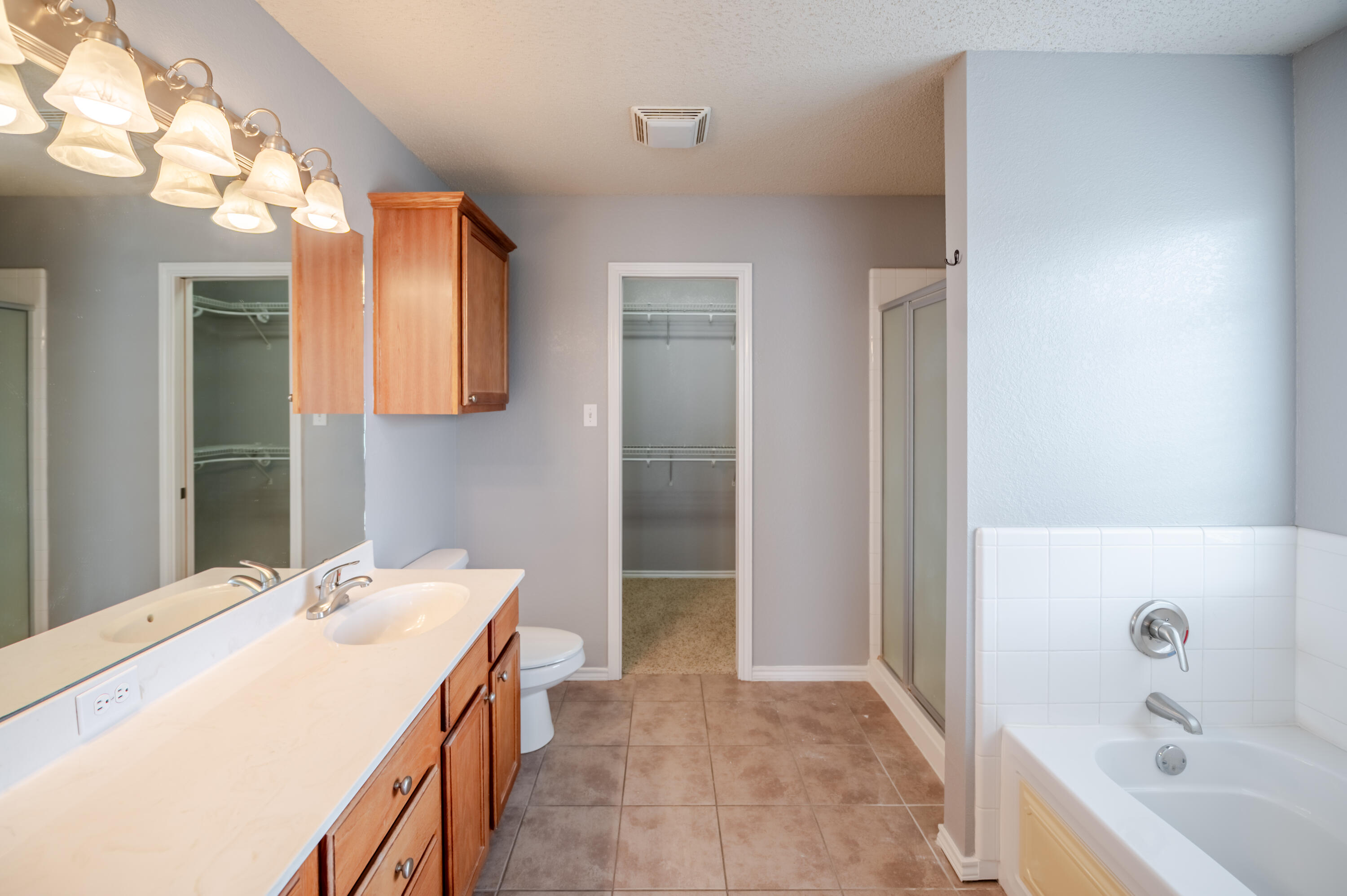 2111 Main Street, Unit 1 Lubbock, TX 79401 - Photo 22 of 36 a bathroom with a tub sink and mirror