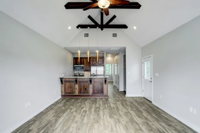 a view of a kitchen with a sink stainless steel appliances and cabinets