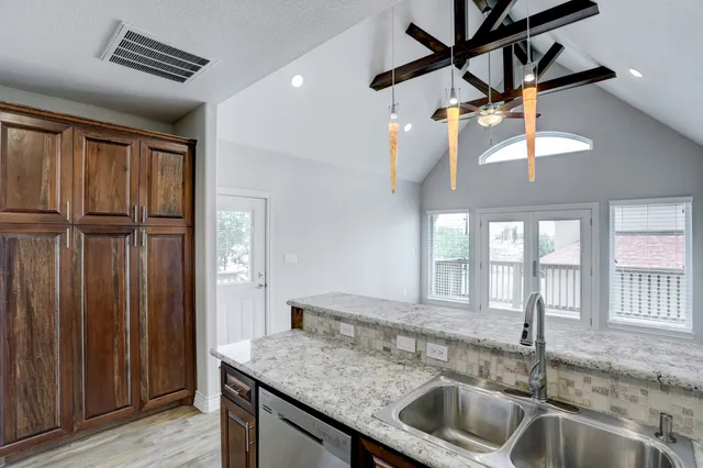 a kitchen with a sink a counter top space and cabinets