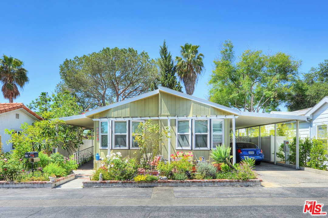 1165 Cherokee Topanga, CA 90290 - Photo 2 of 18 a front view of a house with a garden and plants