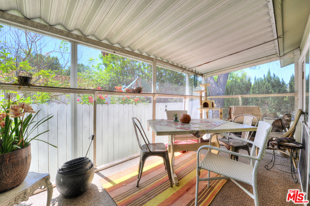 1165 Cherokee Topanga, CA 90290 - Photo 11 of 18 a view of a patio with table and chairs and potted plants