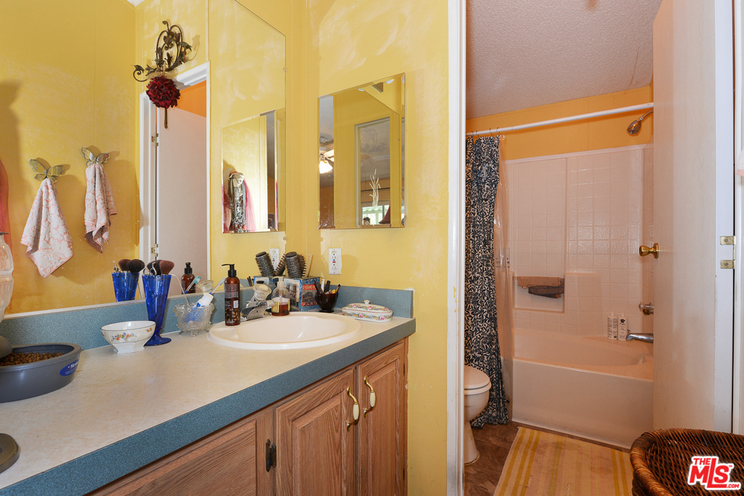1165 Cherokee Topanga, CA 90290 - Photo 9 of 18 a bathroom with a sink and a mirror