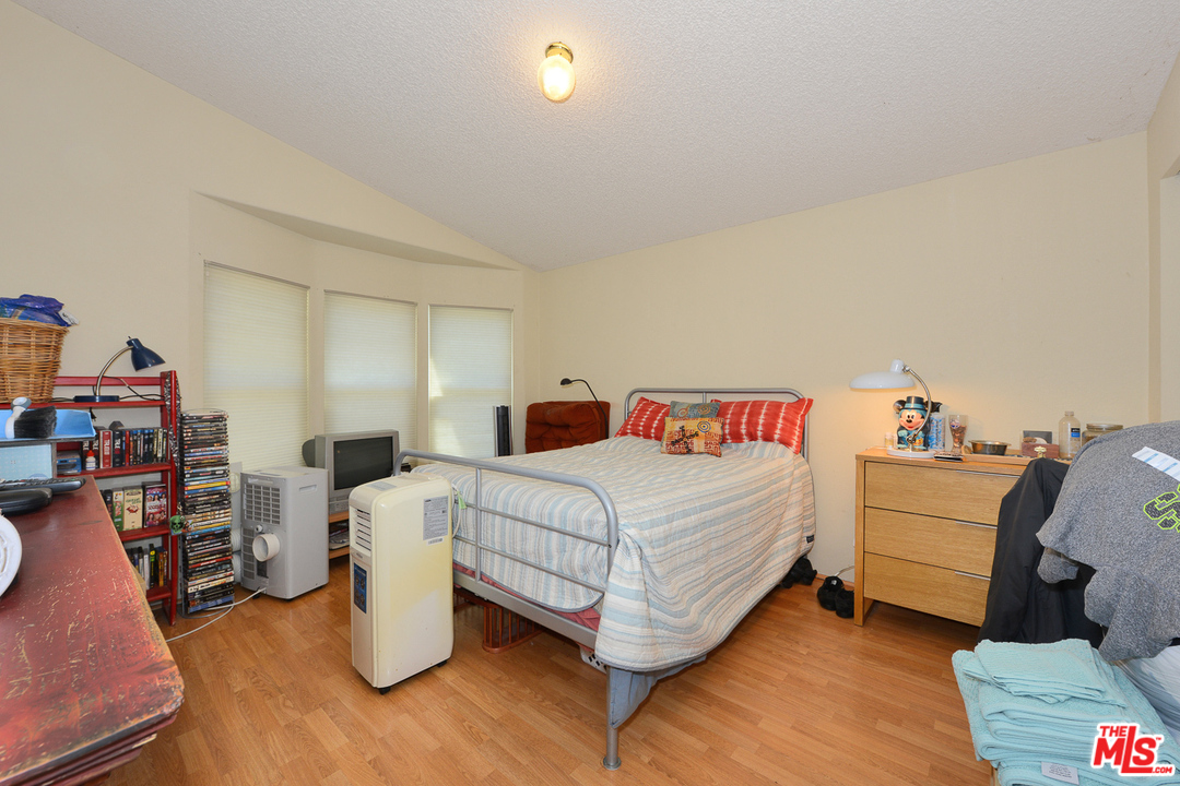 1165 Cherokee Topanga, CA 90290 - Photo 10 of 18 a bedroom with bed and a chandelier