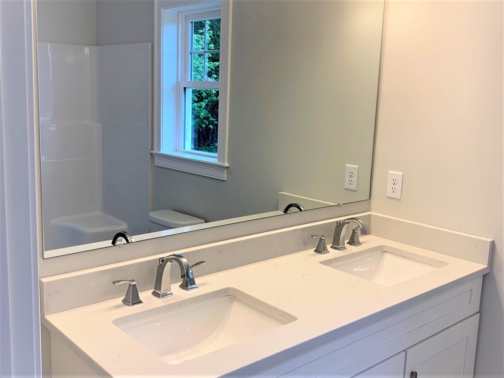 21 Shaker Road, Unit B Ayer, MA 01432 - Photo 6 of 16 a bathroom with a sink and a mirror