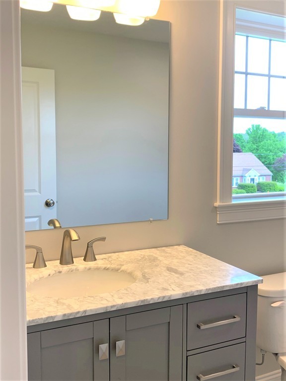 21 Shaker Road, Unit B Ayer, MA 01432 - Photo 9 of 16 a bathroom with a granite countertop sink and a window