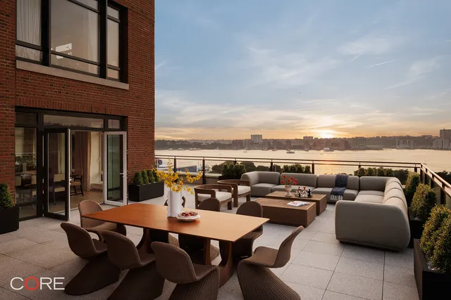 a terrace with outdoor seating and city view