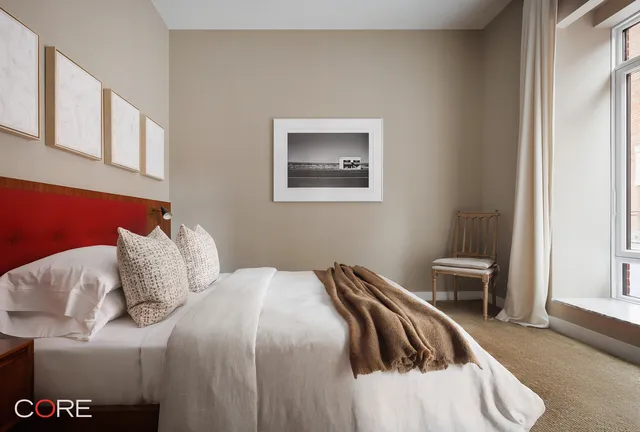 a bedroom with a bed and chair