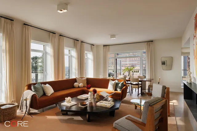 a living room with furniture and large windows