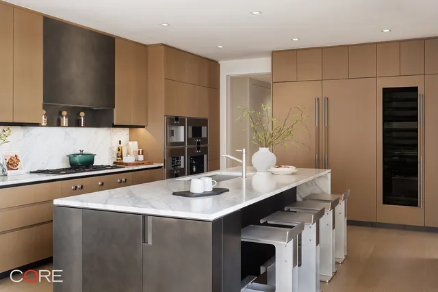 a kitchen with stainless steel appliances a sink a stove and refrigerator