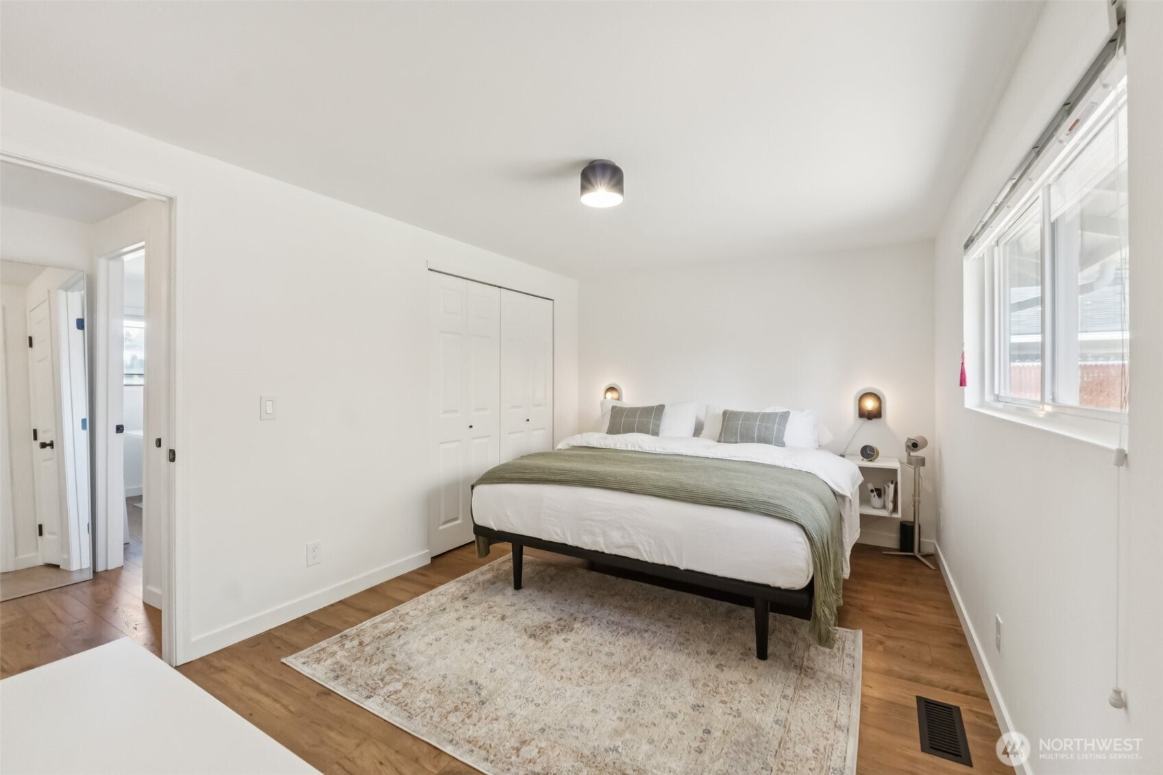 16602 126th Avenue Southeast Renton, WA 98058 - Photo 14 of 30 a spacious bedroom with a bed and wooden floor