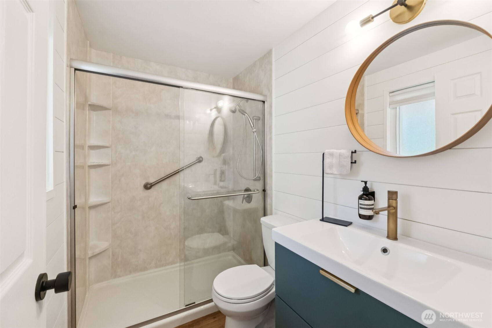 16602 126th Avenue Southeast Renton, WA 98058 - Photo 16 of 30 a bathroom with a sink a toilet and a mirror