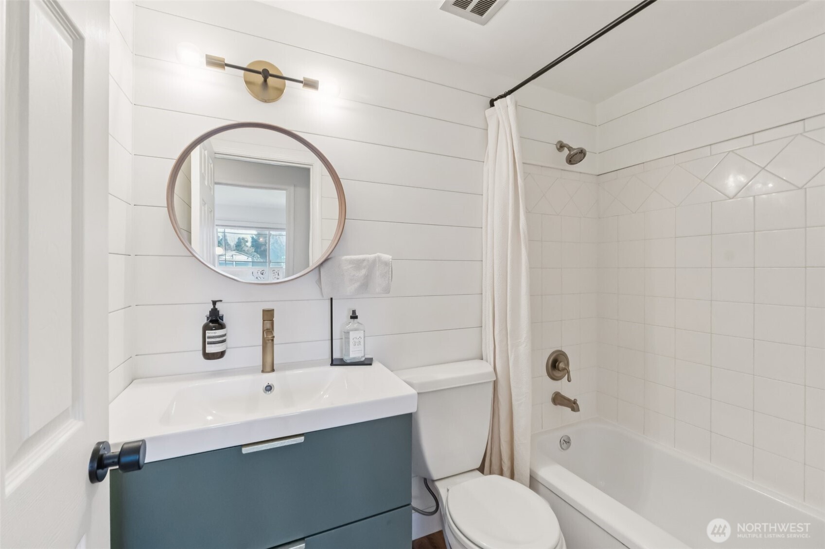 16602 126th Avenue Southeast Renton, WA 98058 - Photo 18 of 30 a bathroom with a sink a toilet and a mirror