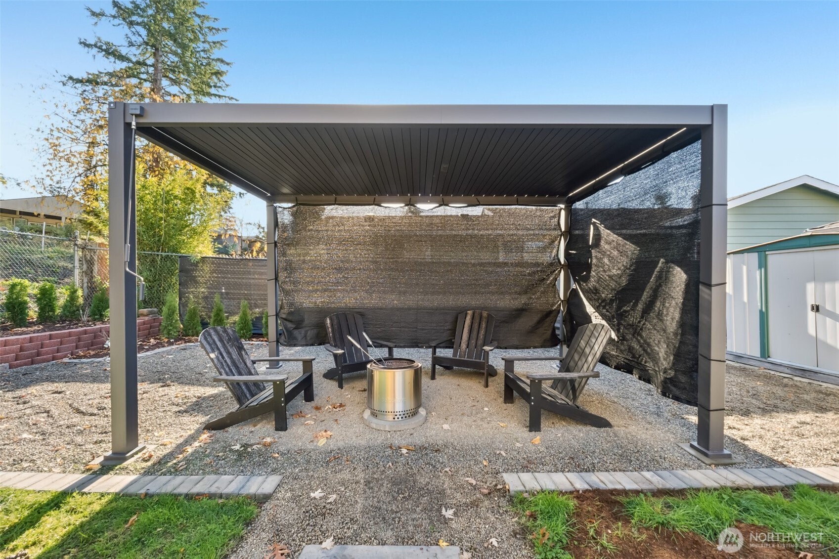 16602 126th Avenue Southeast Renton, WA 98058 - Photo 26 of 30 a view of a patio with table and chairs under an umbrella