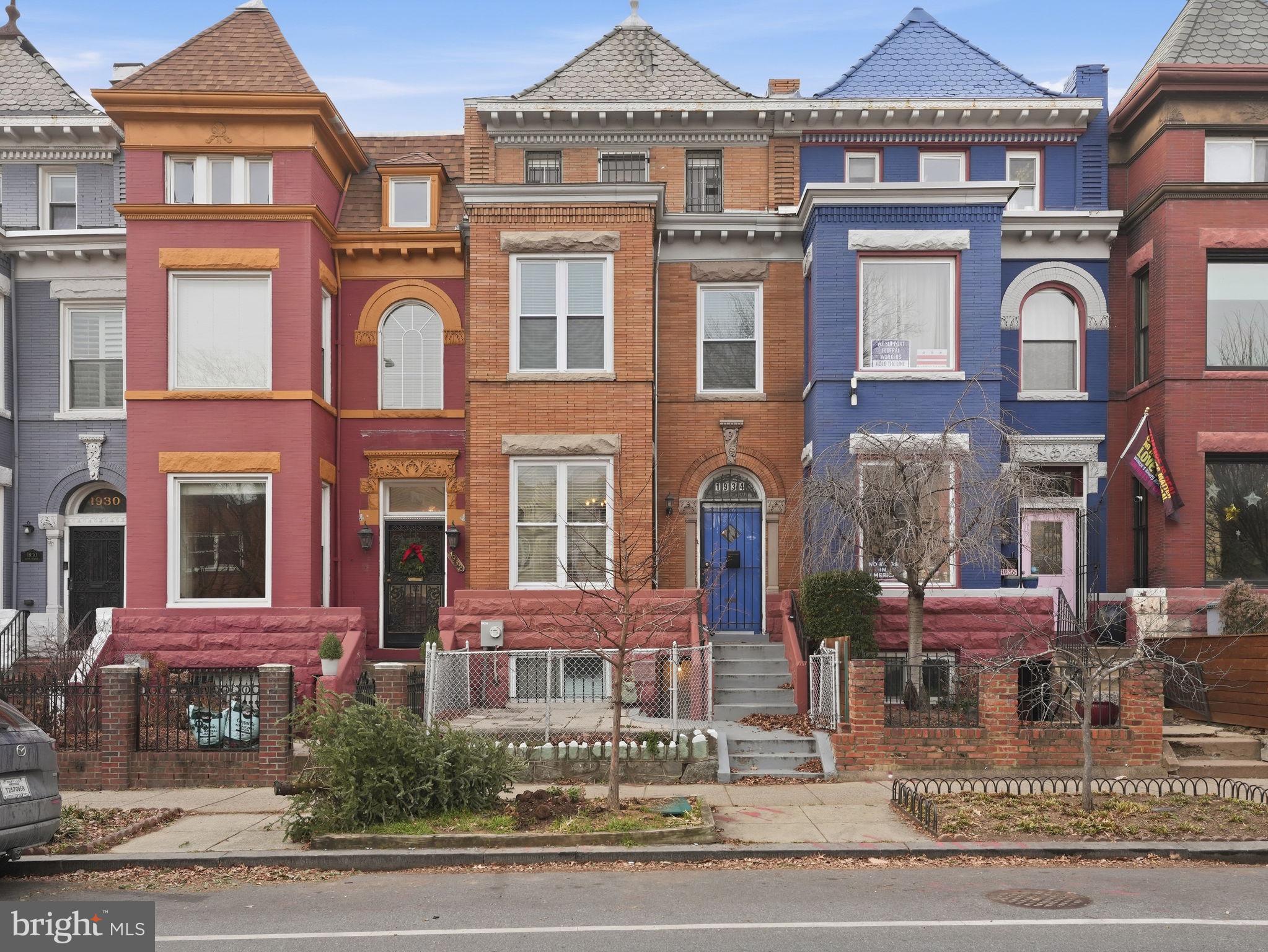 a front view of a residential apartment building with a yard