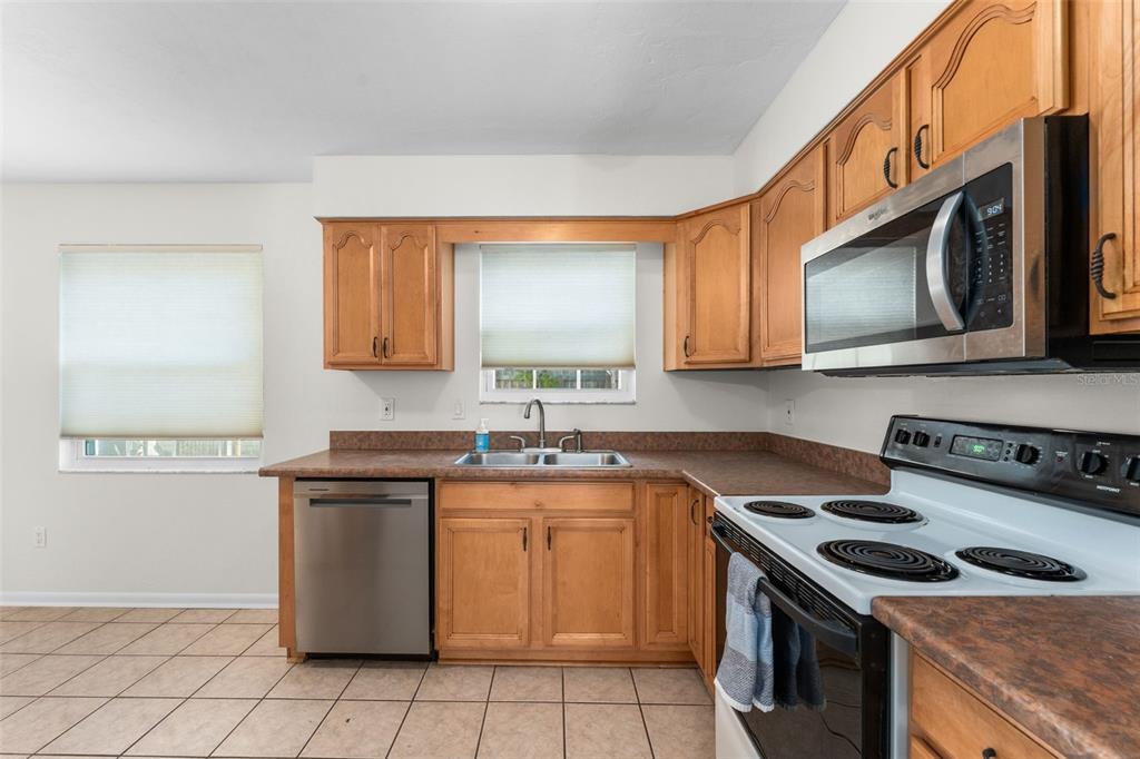 2026 Southwest 73rd Street Gainesville, FL 32607 - Photo 2 of 20 a kitchen with a stove sink and cabinets