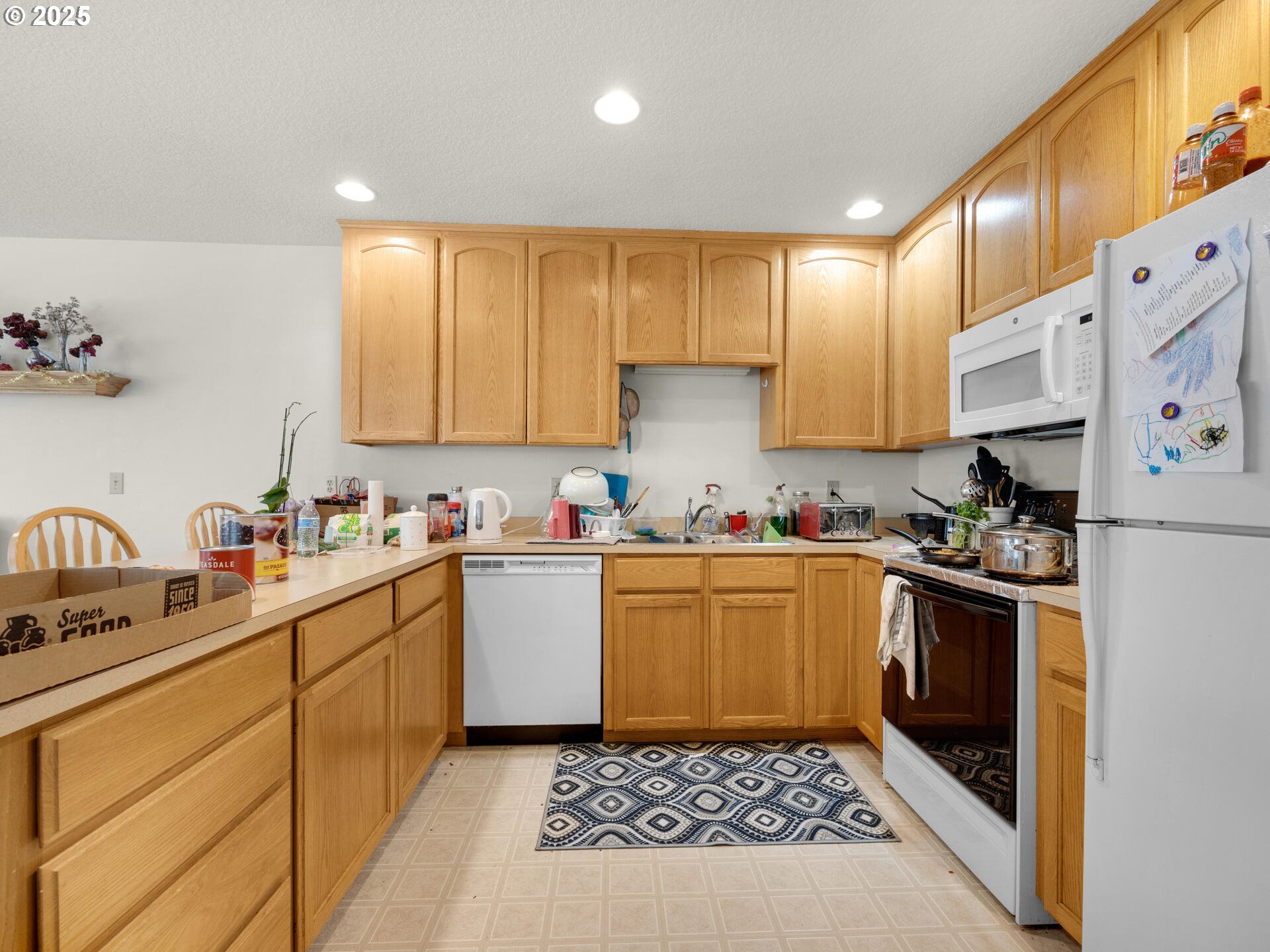 107 Sunset Boulevard Cannon Beach, OR 97110 - Photo 20 of 25 a kitchen with granite countertop a sink a stove top oven and cabinets