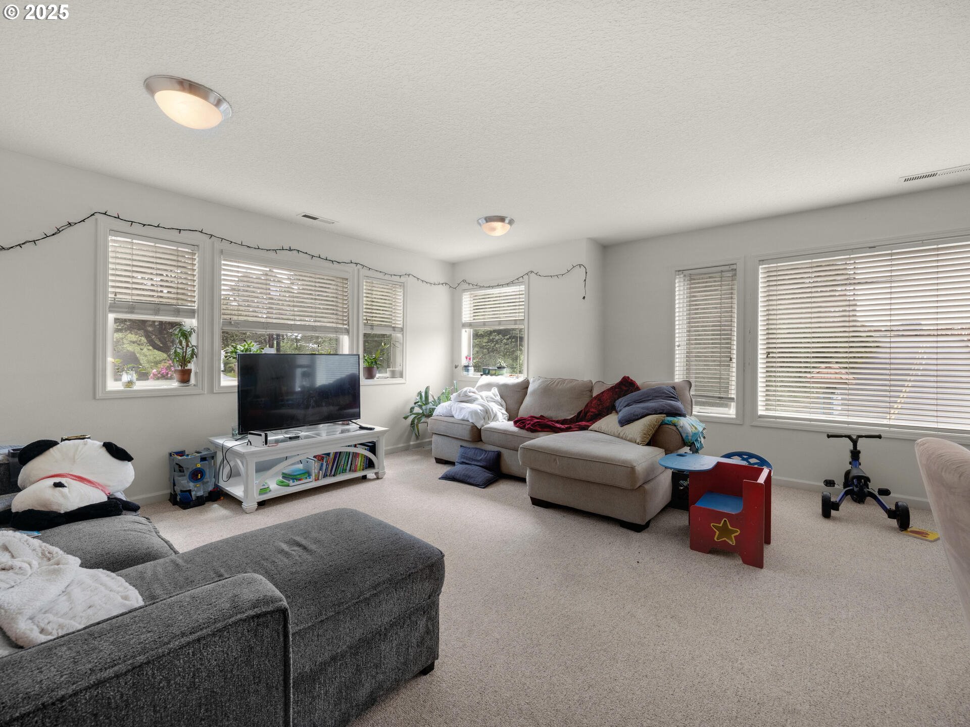 107 Sunset Boulevard Cannon Beach, OR 97110 - Photo 21 of 25 a living room with furniture a window and a flat screen tv