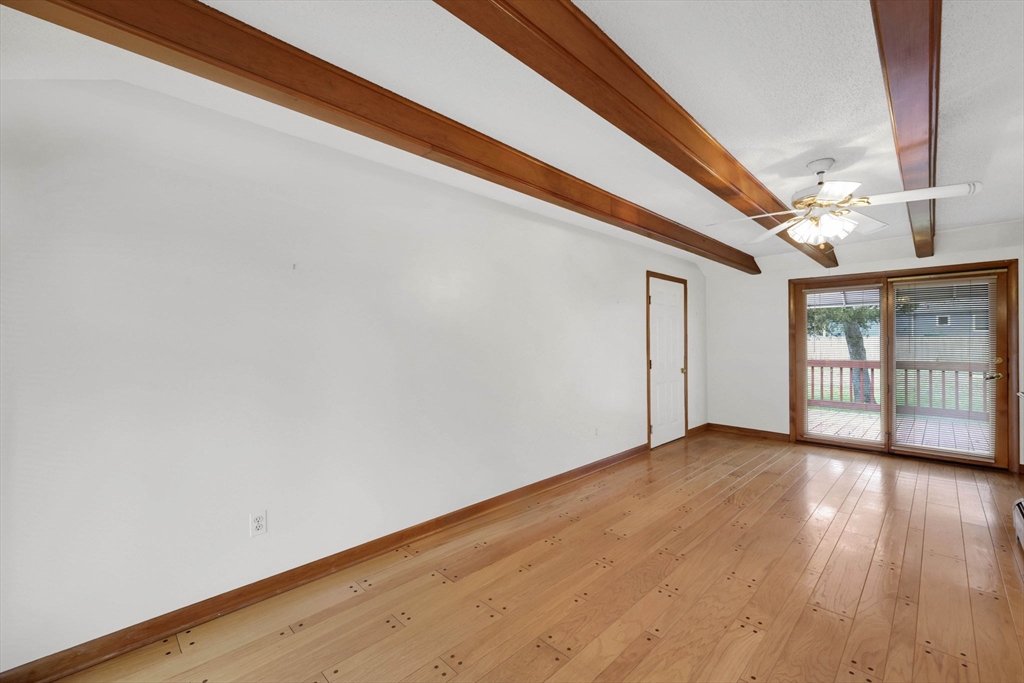193 Marmon Street Springfield, MA 01129 - Photo 12 of 26 a view of an empty room with wooden floor and a window