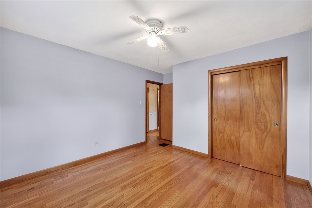 193 Marmon Street Springfield, MA 01129 - Photo 19 of 26 an empty room with wooden floor and fan