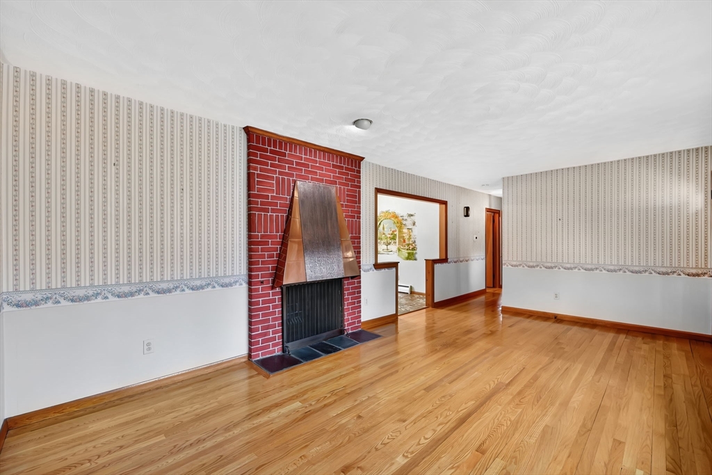 193 Marmon Street Springfield, MA 01129 - Photo 3 of 26 an empty room with wooden floor and windows