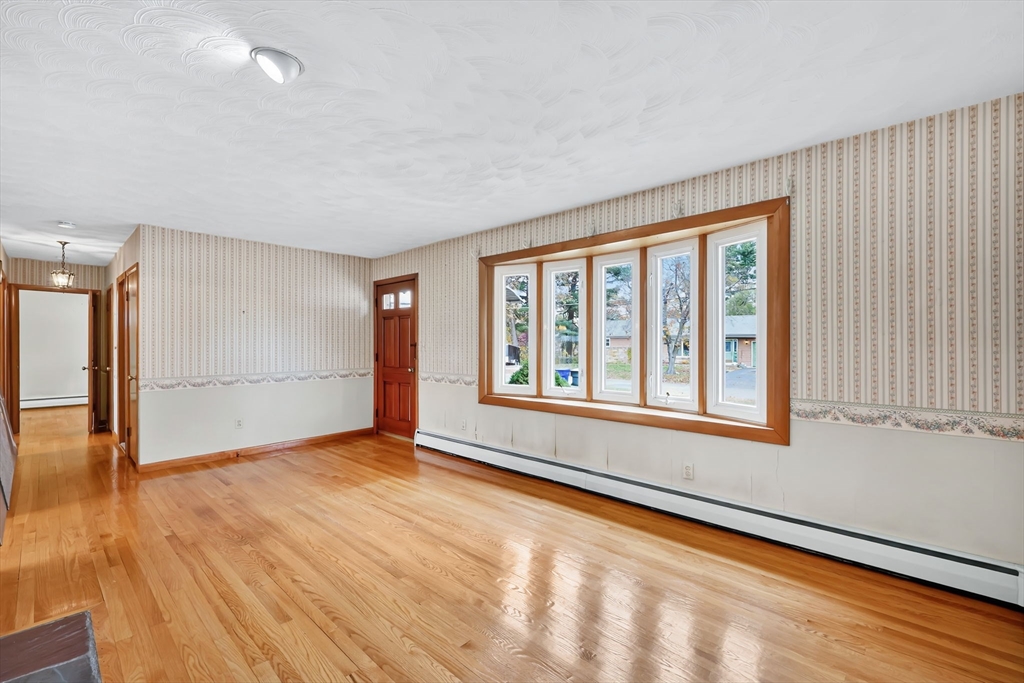193 Marmon Street Springfield, MA 01129 - Photo 4 of 26 wooden floor in an empty room with a window