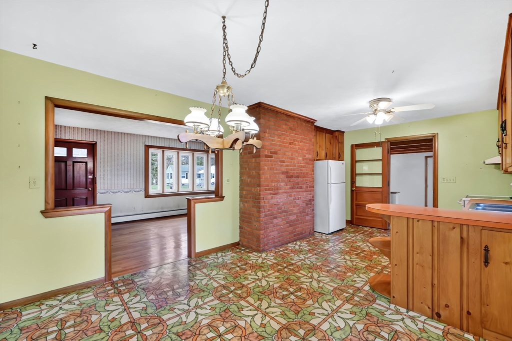 193 Marmon Street Springfield, MA 01129 - Photo 6 of 26 a view of a hallway with wooden floor and chandelier