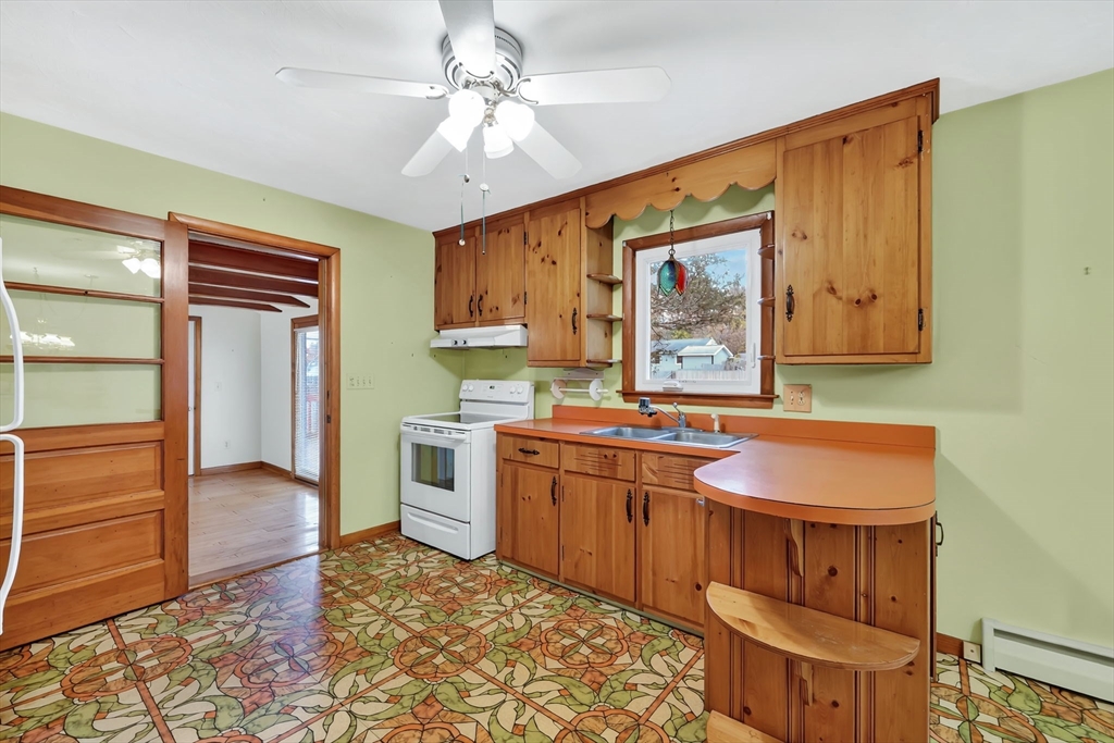 193 Marmon Street Springfield, MA 01129 - Photo 8 of 26 a kitchen with a stove a sink and a refrigerator