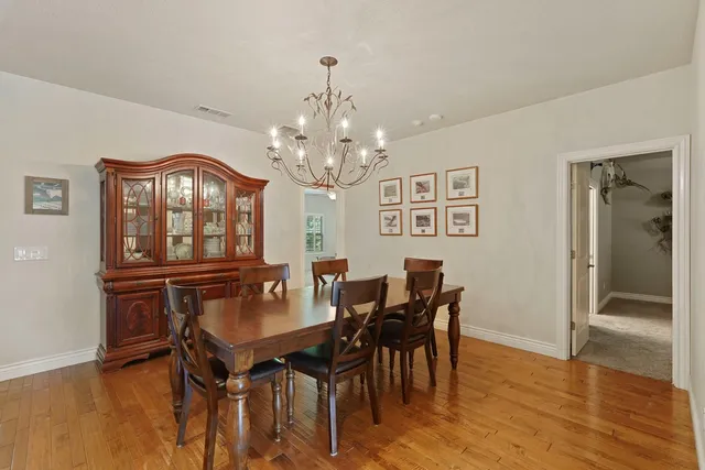 a view of a dining room with furniture and a chandelier