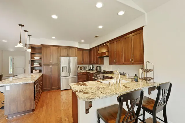 a kitchen with refrigerator and cabinets