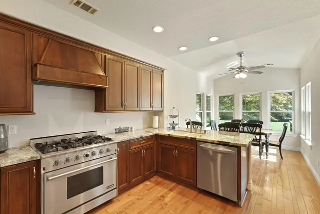 a kitchen with a sink stove and cabinets