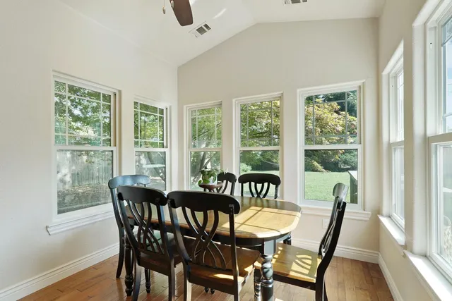 a view of a dining room with furniture window and wooden floor