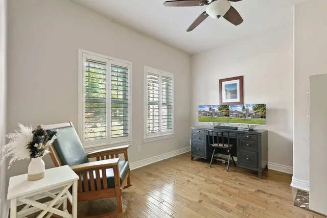 a view of a workspace with furniture and a window