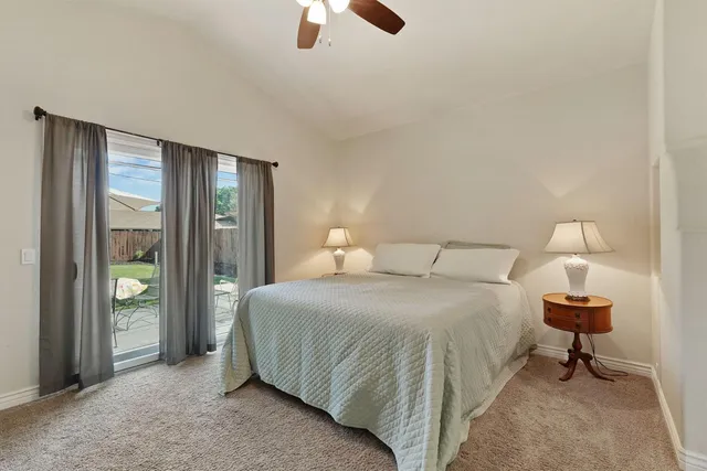 a bedroom with a bed and a lamp