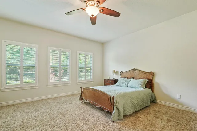 a spacious bedroom with a bed and a window