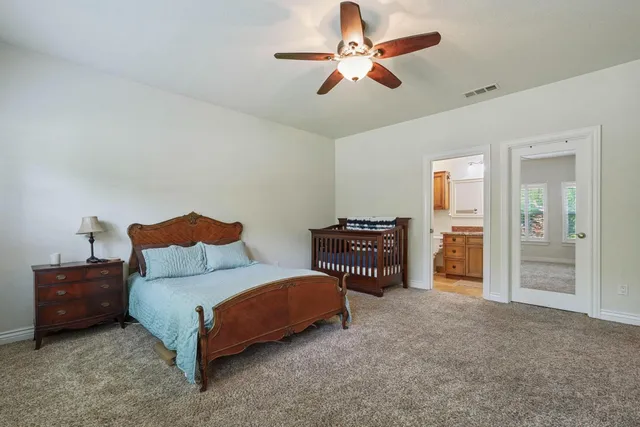 a living room with furniture and a ceiling fan