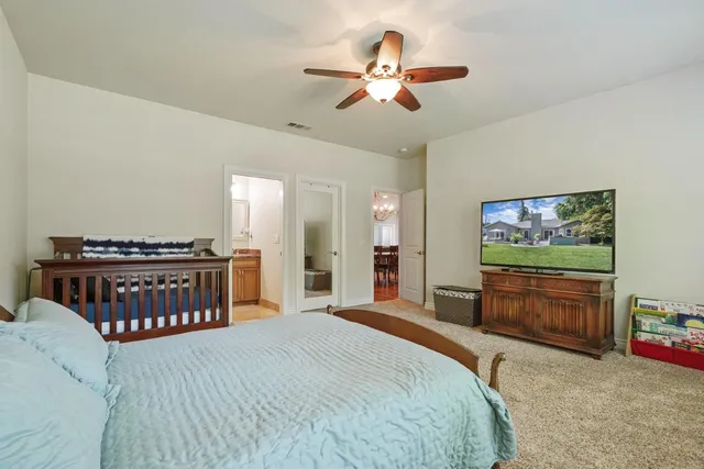 a bedroom with a bed and a chandelier