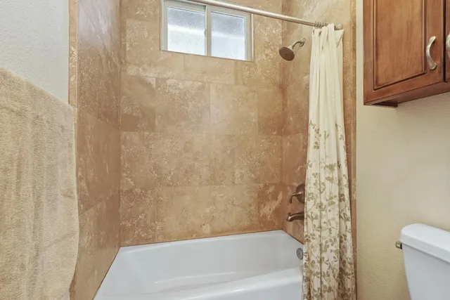 a bathroom with a shower and a toilet