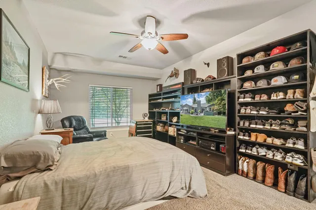 a bedroom with a bed window and flat screen tv