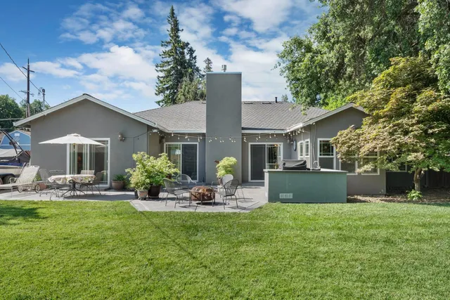 a front view of house with yard and outdoor seating