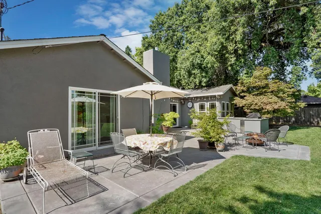 a view of a patio with table and chairs and potted plants