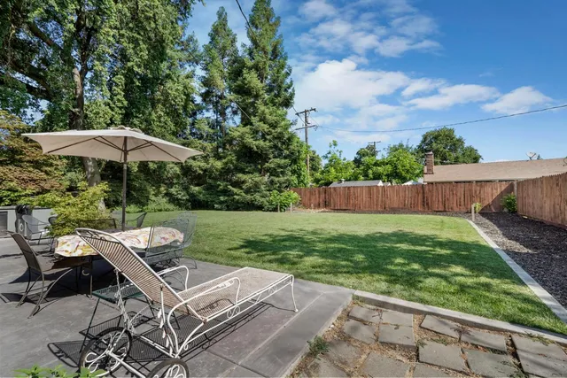 a view of a yard with furniture and a garden
