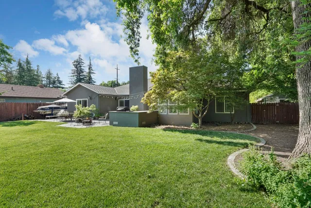 a view of a house with a yard and sitting area