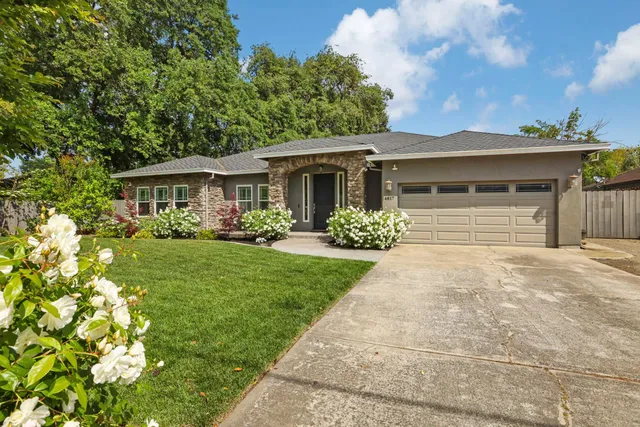 a front view of a house with garden