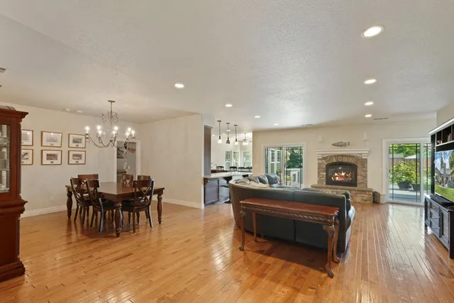a living room with furniture a dining table and a chandelier