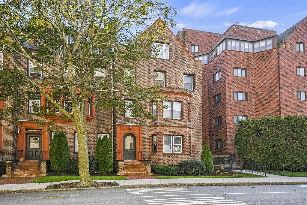 a view of a brick building next to a yard