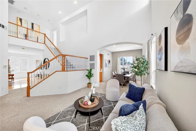 a living room with furniture and flowers