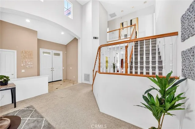a living room with furniture a dining table and a potted plant