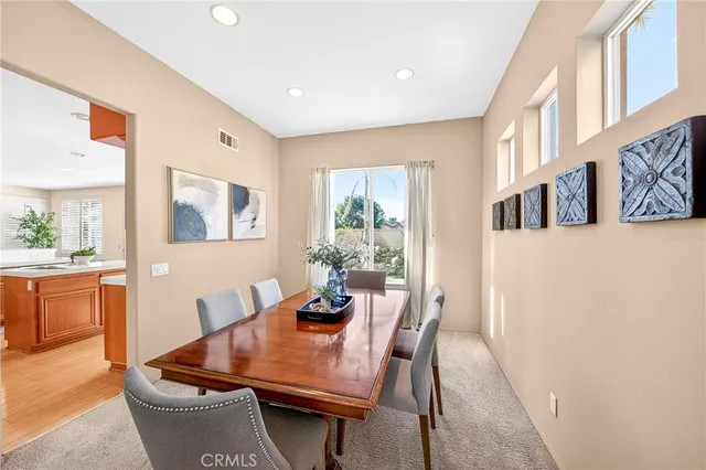 a kitchen with stainless steel appliances granite countertop a stove a sink dishwasher and a refrigerator with wooden floor